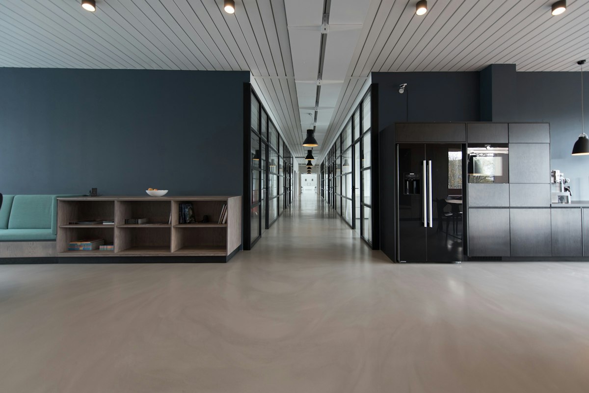 Modern law office hallway lined with glass-walled conference rooms